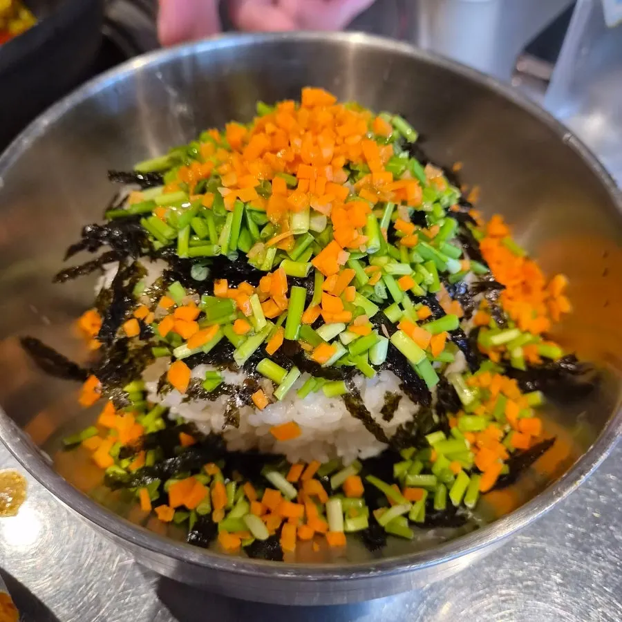 Staff stir-frying fried rice in the leftover broth