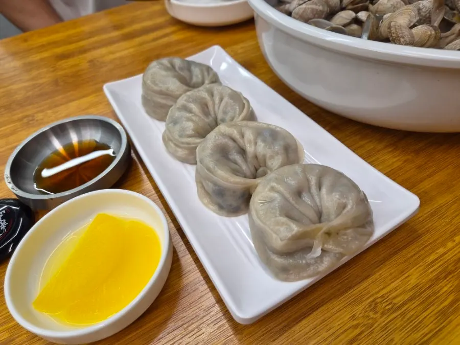 Buckwheat clam kalguksu piled high with clams