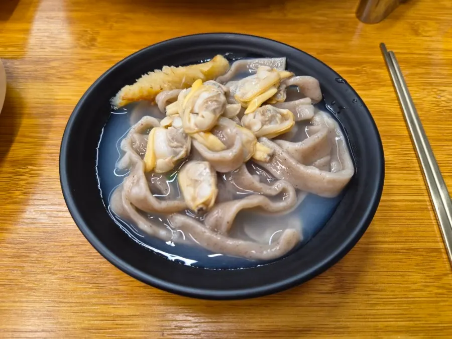 Cross-section of dark-colored king mandu made with buckwheat wrapper
