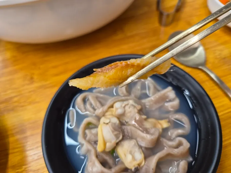 Close-up of the milky broth and pure buckwheat noodles