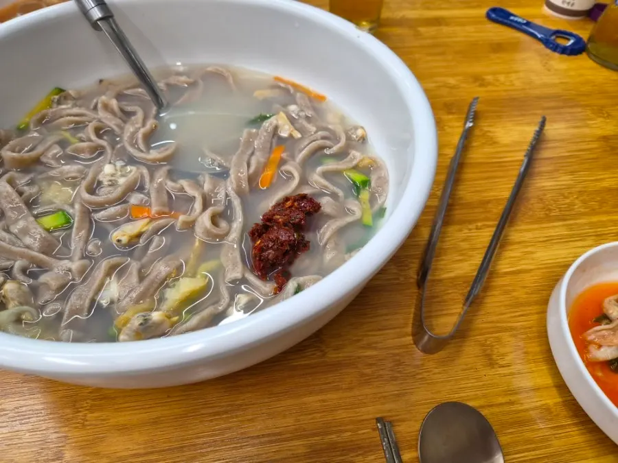 Kalguksu broth with large chunks of dried pollack