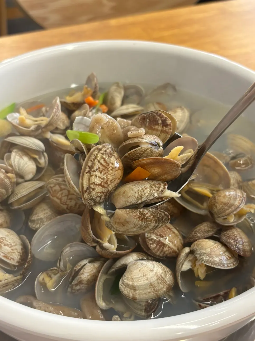 Close-up of clams piled on top of the noodle soup