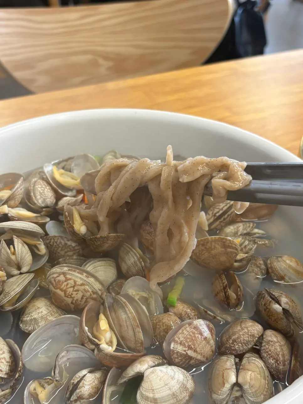 Buckwheat noodle strands lifted from the bowl