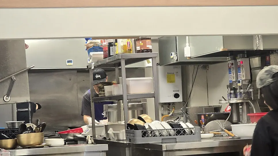 Open kitchen visible behind the counter