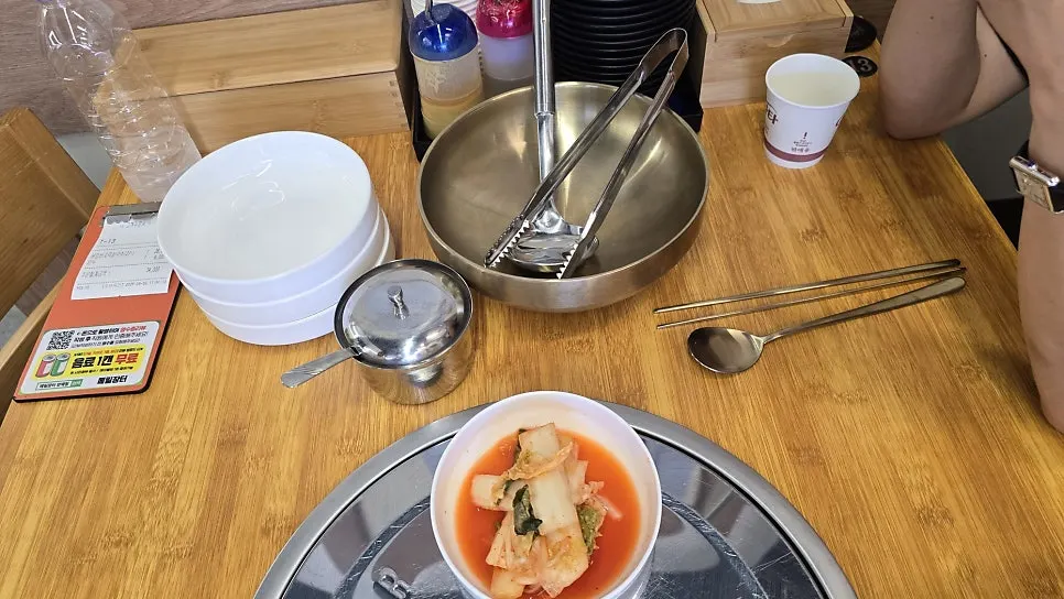 Table set with tongs and a stainless bowl for clam shells