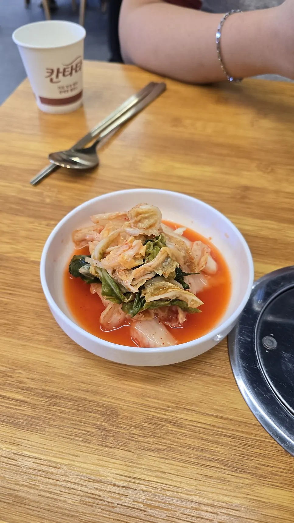 Side dish of red kimchi with a watery broth