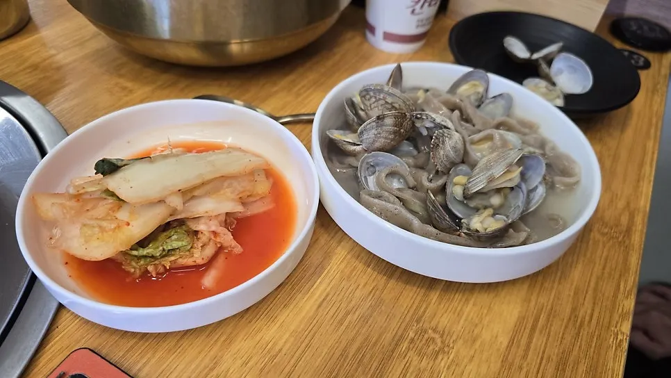 Kalguksu broth and noodles scooped into a side plate