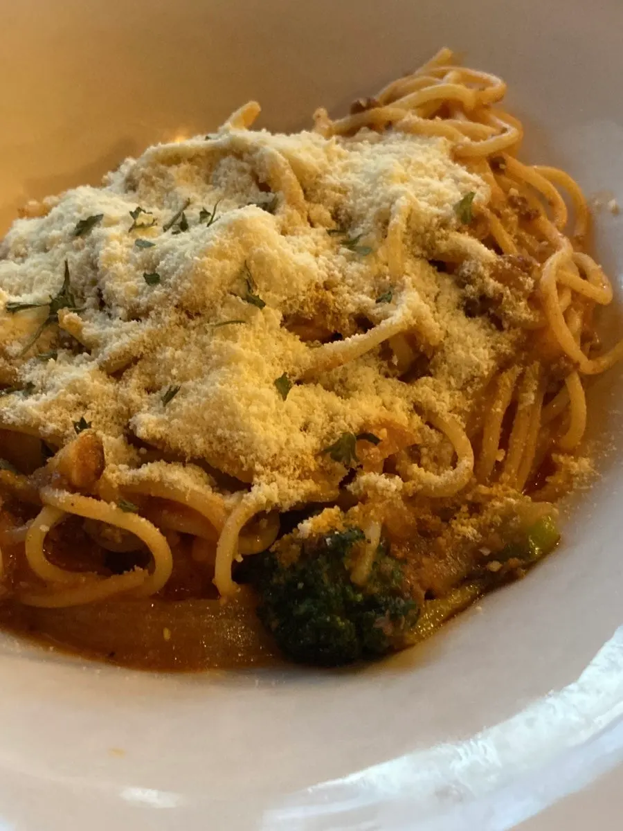 Bolognese pasta topped with grated cheese