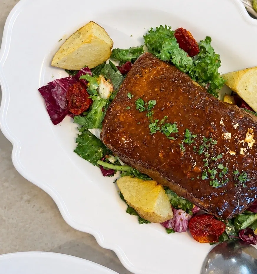 Salmon steak served with salad