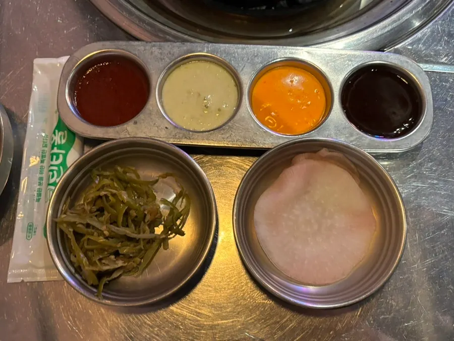 Basic table setting with four sauces and pickled radish