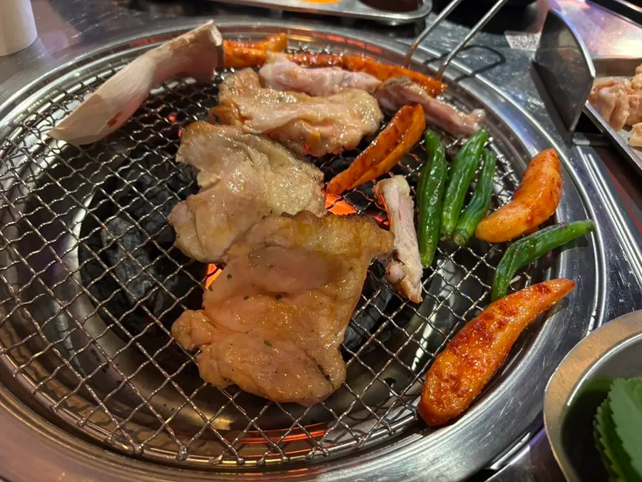 Grilled deodeok and dakgalbi over charcoal