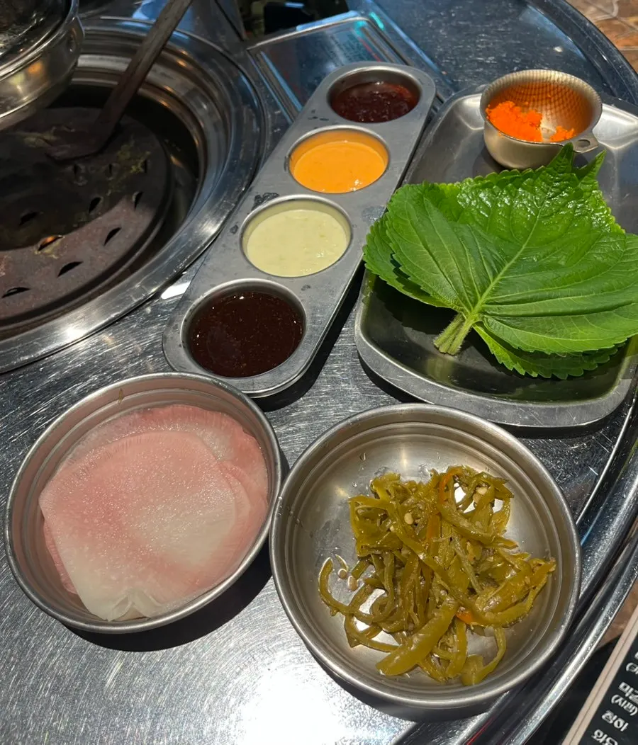 Basic side dish spread with perilla leaves, radish wraps, fish roe and four sauces