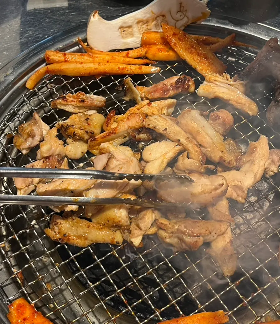 Dakgalbi platter set on the charcoal grill