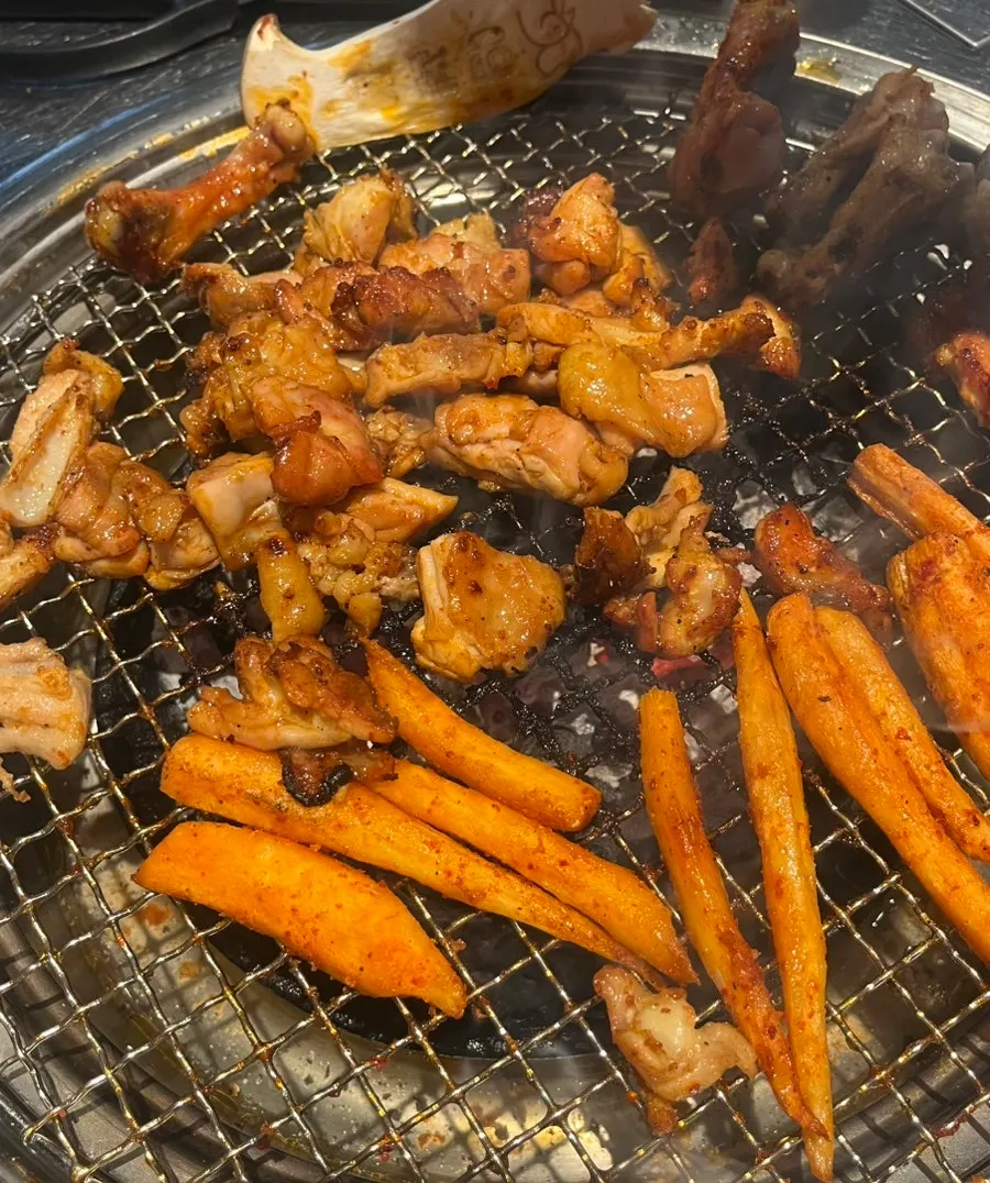 Gochujang dakgalbi placed on the charcoal grill