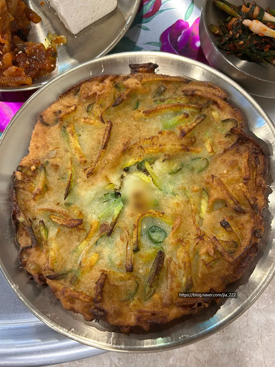 A plate of golden, freshly fried zucchini pancake