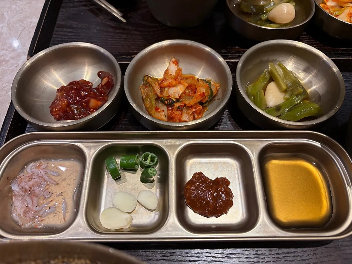 Side dishes including kimchi and pickled vegetables
