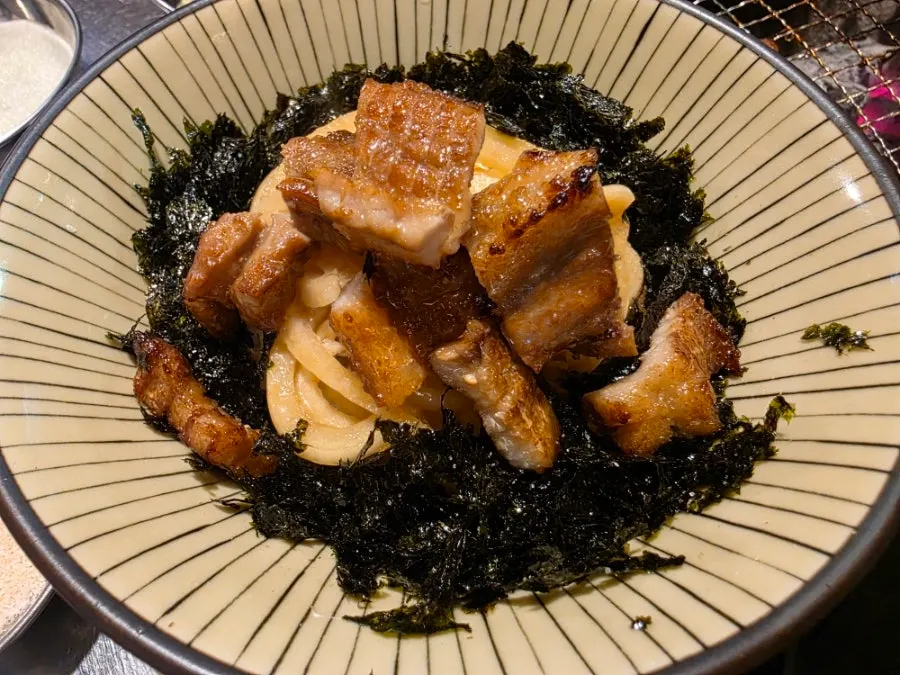 Donburi rice topped with soy-sauce onions and seaweed