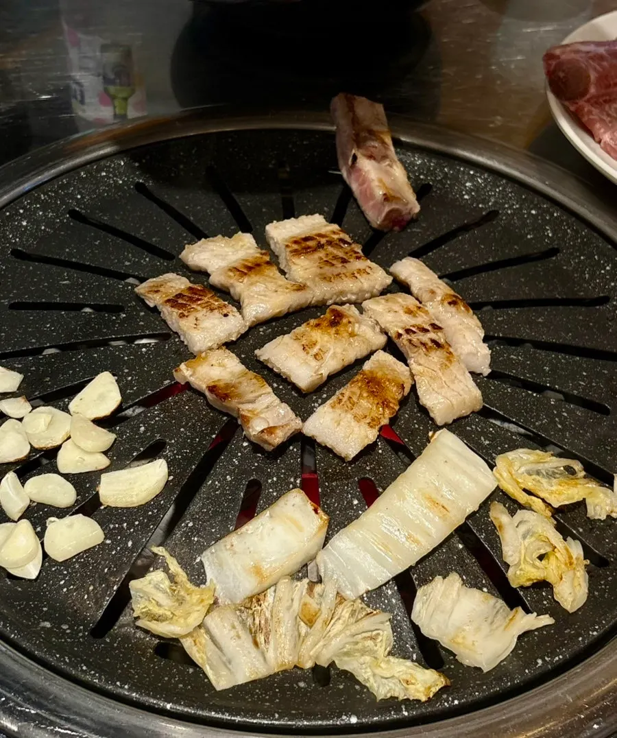 Raw ribs grilling together with white kimchi