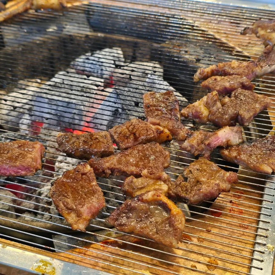 Handmade LA galbi cooking over charcoal