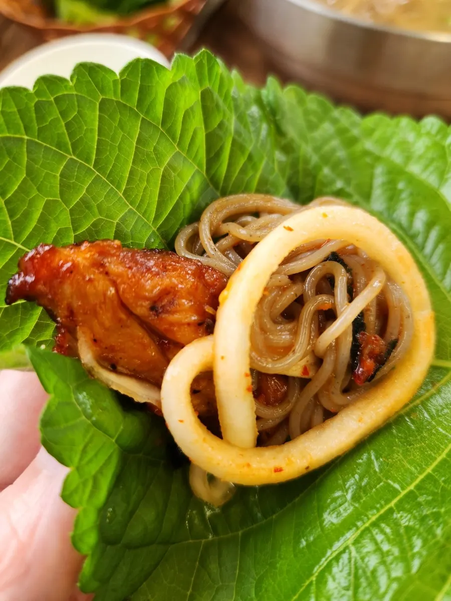 Table with both dakgalbi and makguksu served together