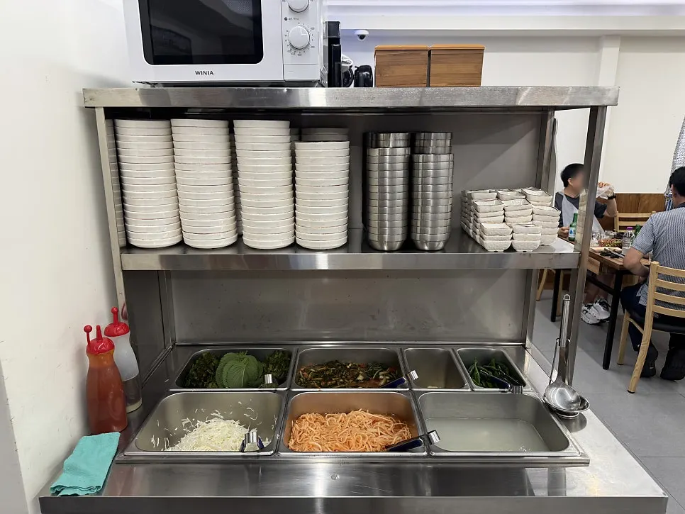 Self-bar stocked with wrap vegetables and kimchi