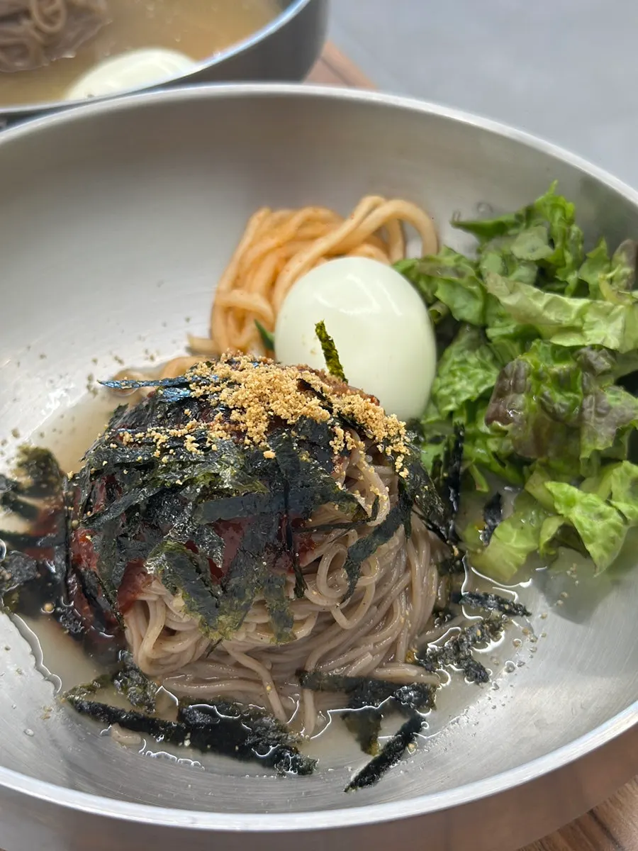 Vertical shot of dakgalbi and makguksu spread