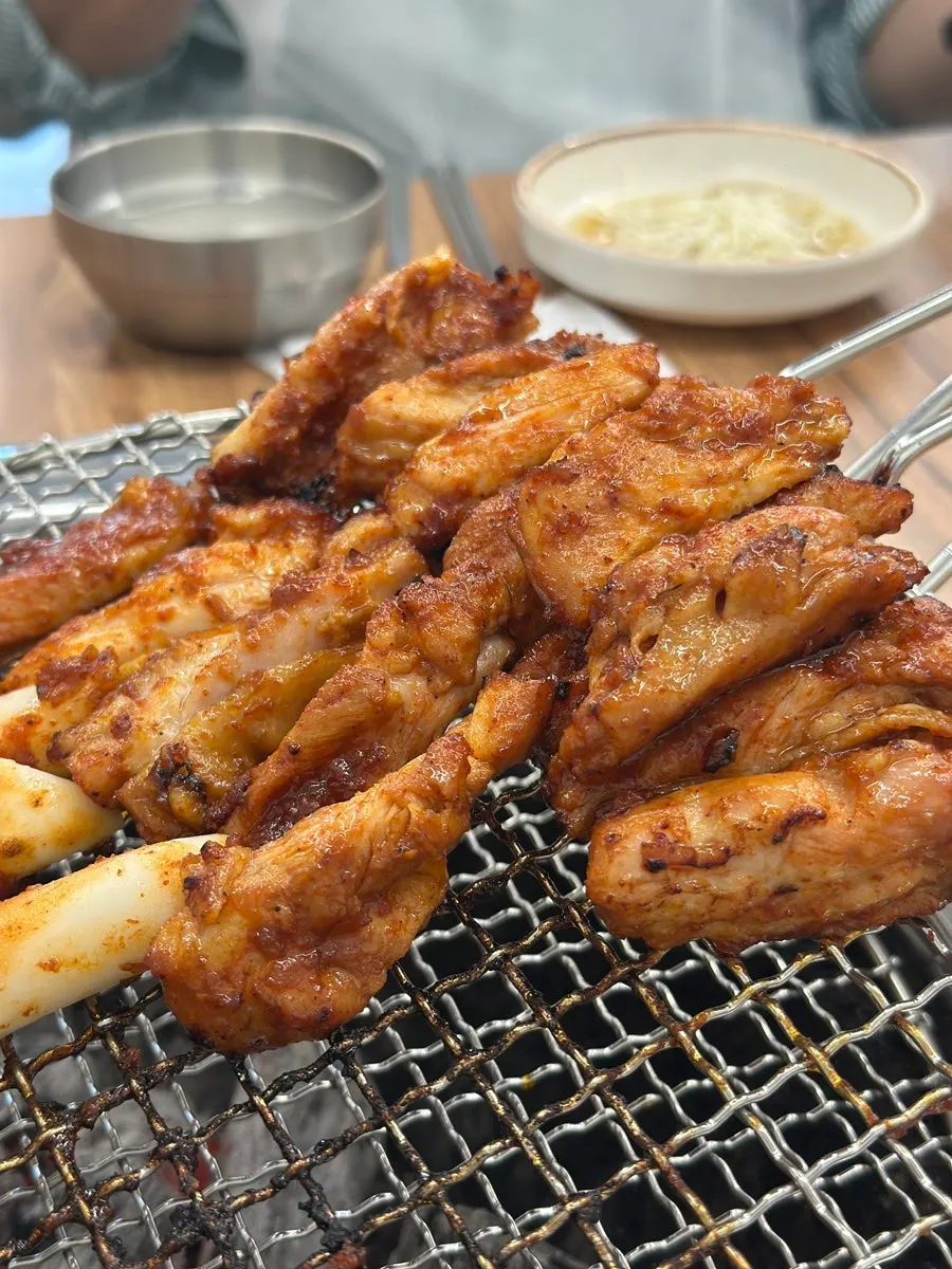 Fully cooked dakgalbi served in stacked pans