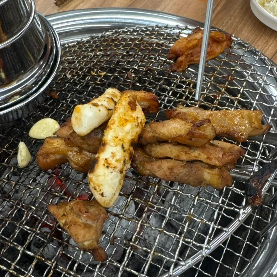 A piece of dakgalbi on a lettuce wrap