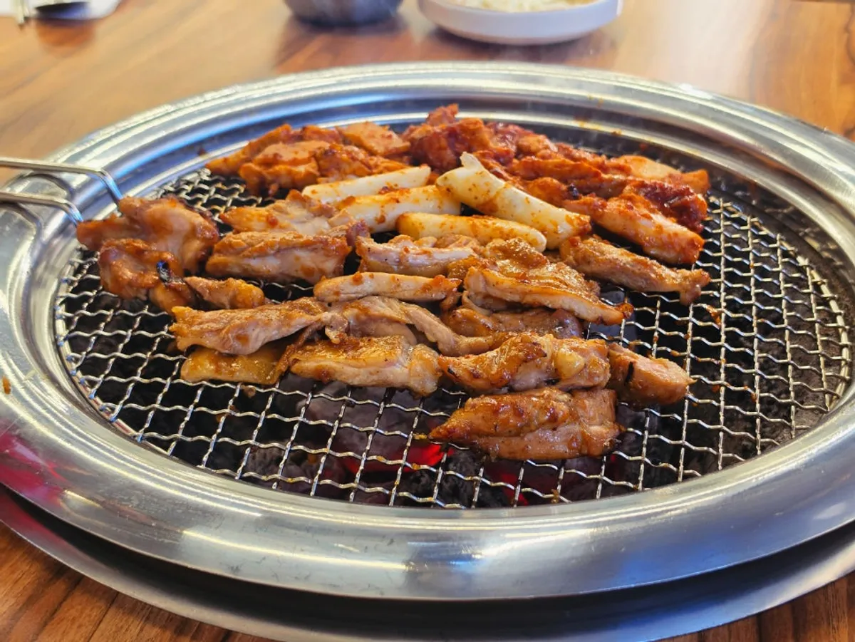 Sweet sauce charcoal dakgalbi on the tabletop grill