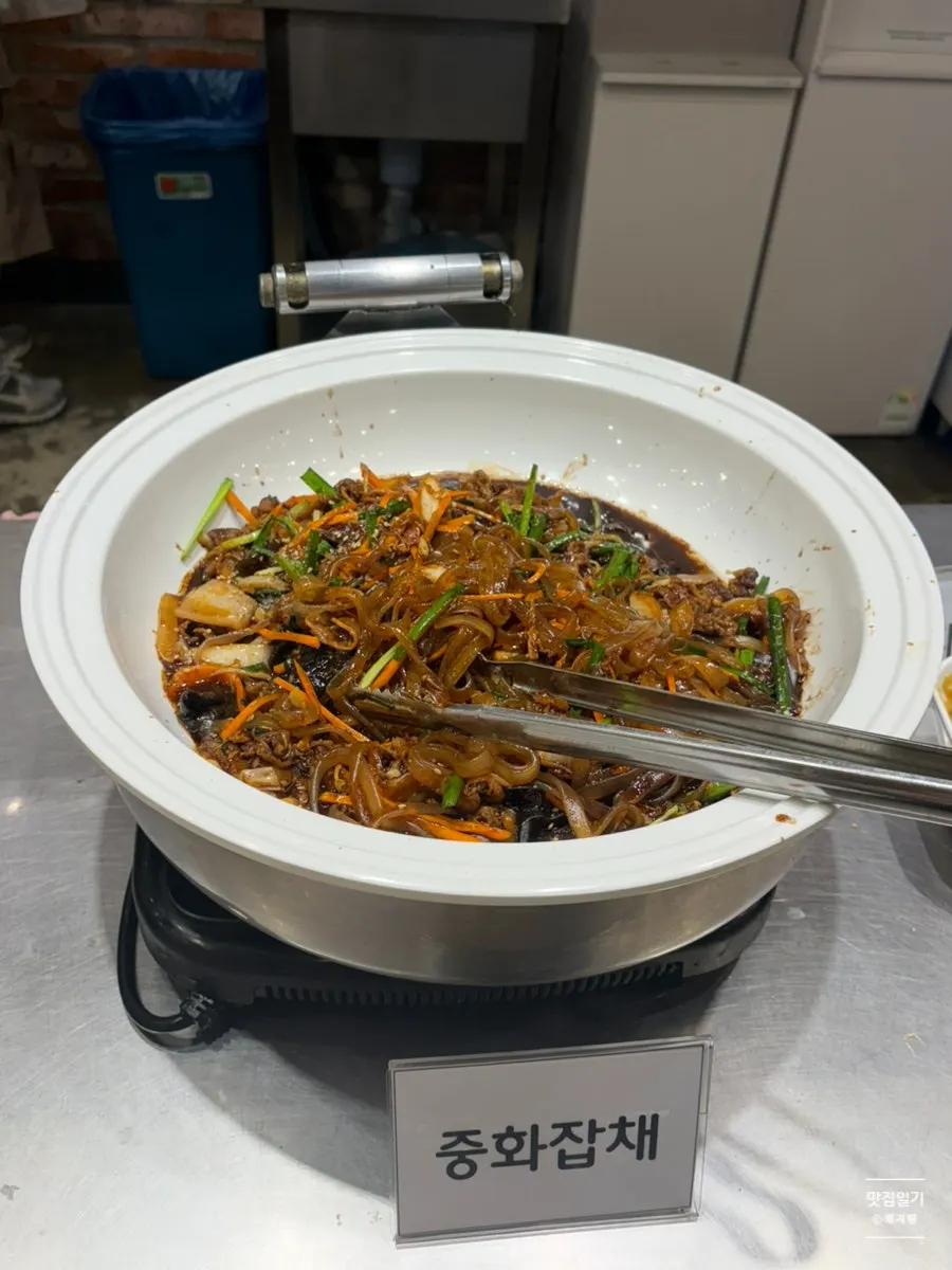 Staff member managing the buffet food corner
