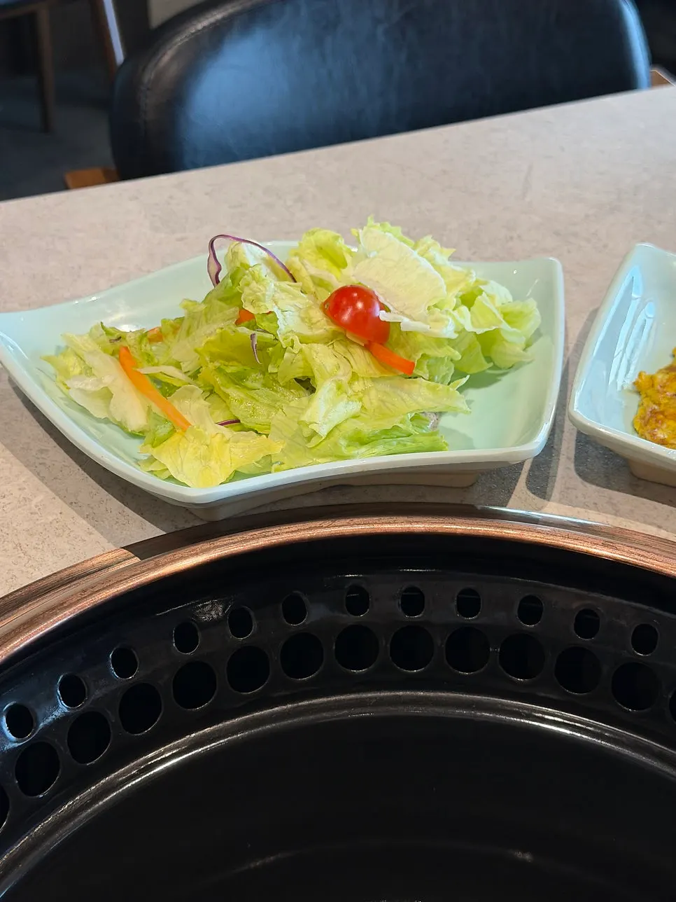 Kimchi side dish plate at Manpo Garden