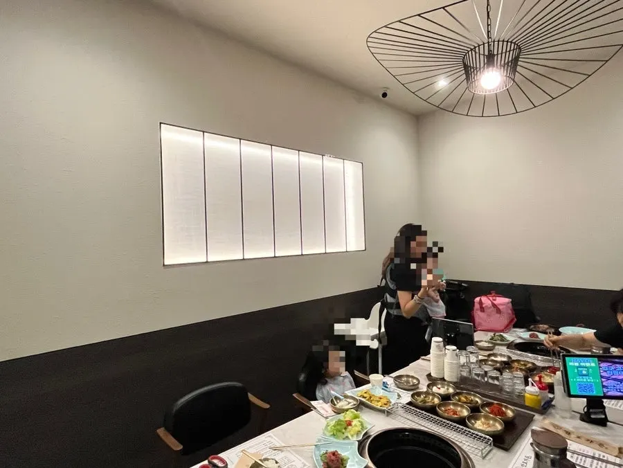 Private room seating at Manpo Garden with side dishes set up