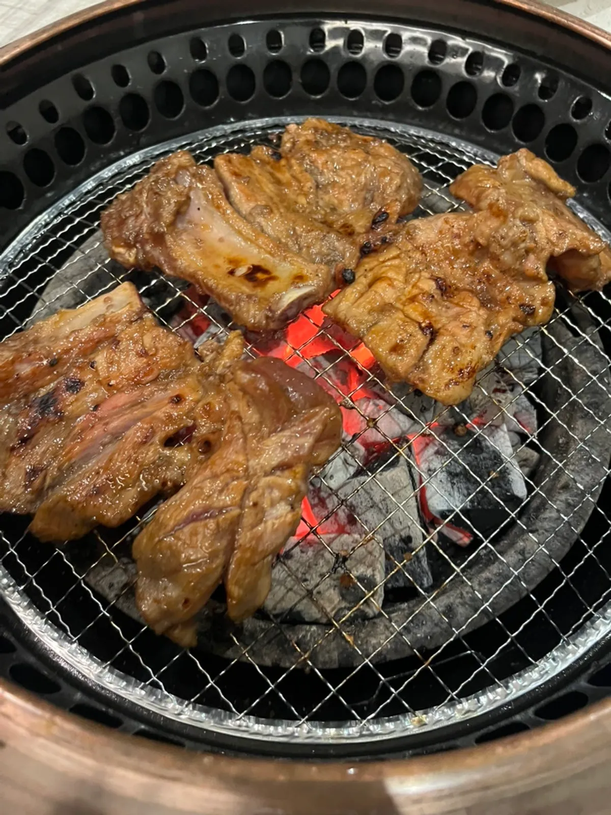 Marinated pork galbi grilling over charcoal