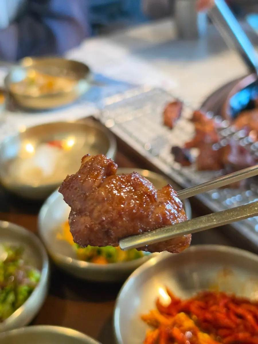 Marinated galbi being flipped carefully to avoid burning
