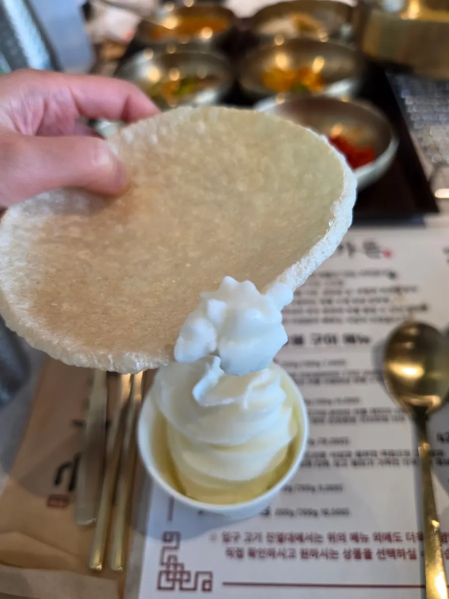 Ice cream in a paper cup with puffed rice snack