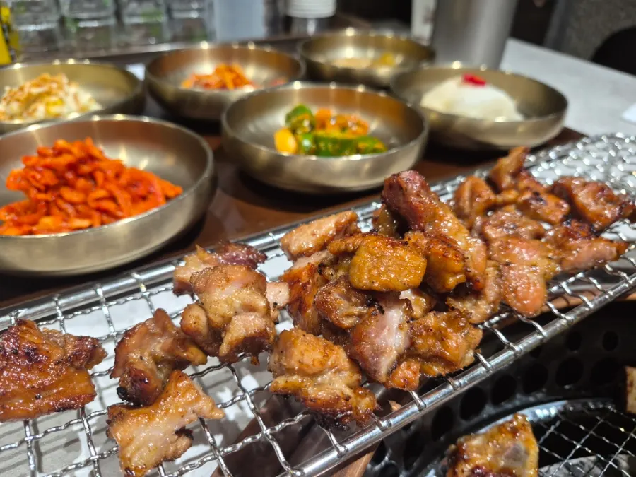 Handmade Korean pork galbi grilling over charcoal