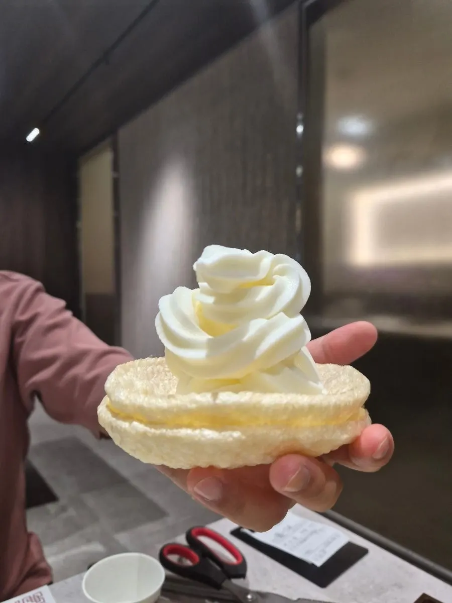 Soft-serve ice cream placed on a puffed rice cracker