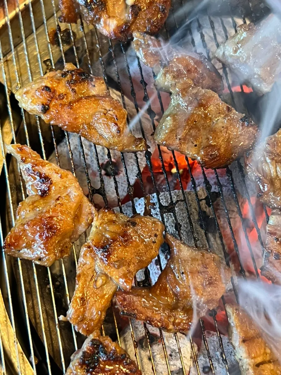 Thick handmade Korean pork galbi placed over charcoal