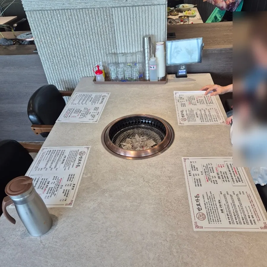 Side dishes and charcoal set out on the table