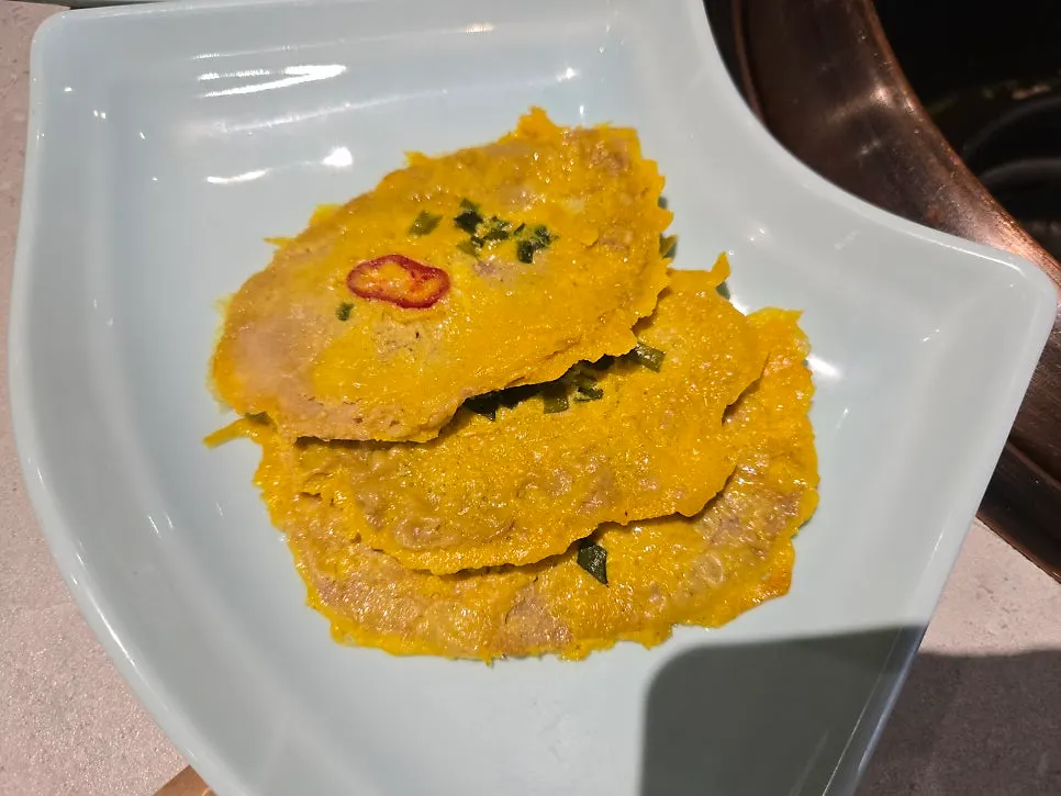 A plate of yukjeon, the egg-battered beef served as standard