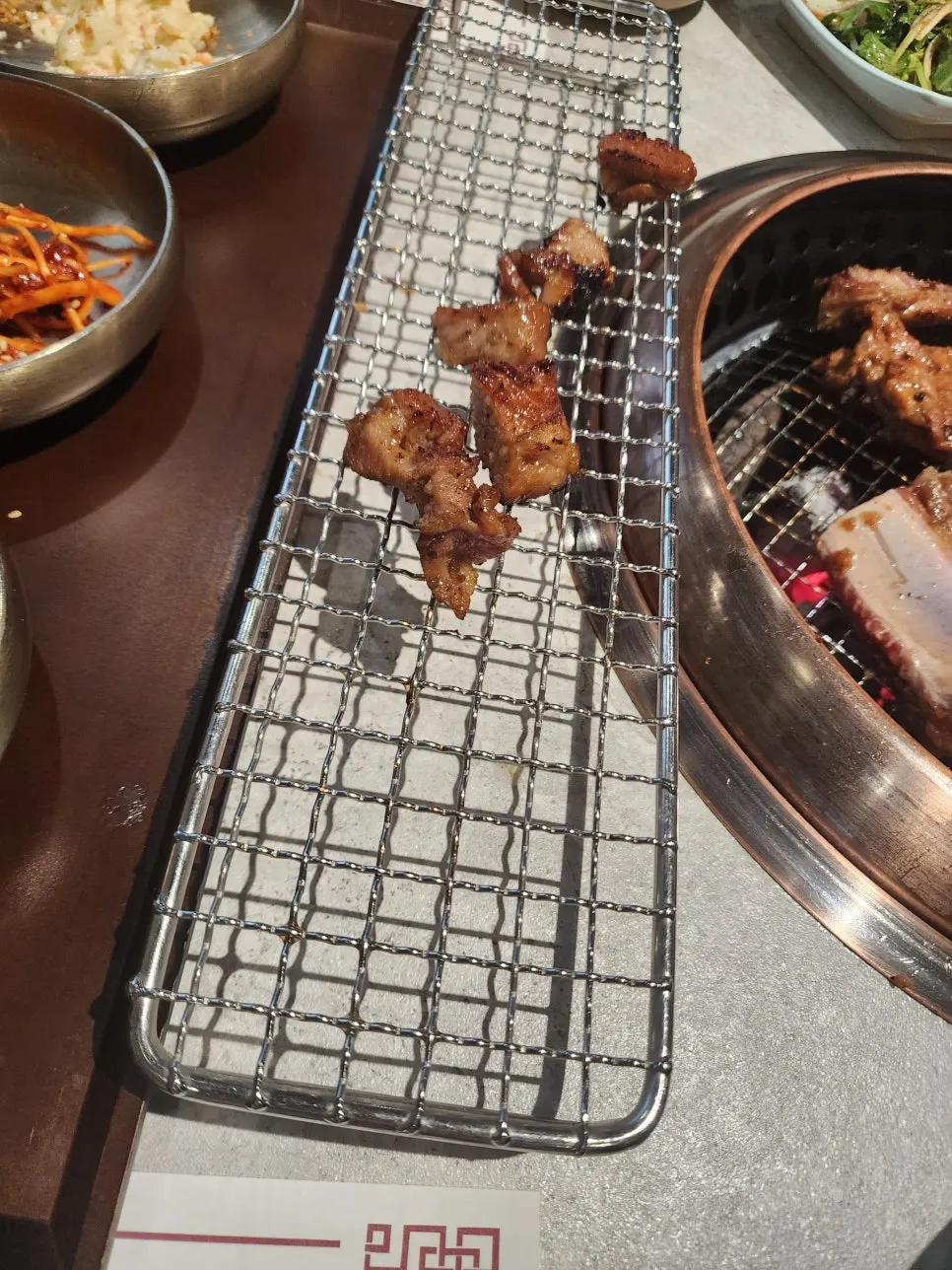 Manpo Garden's marinated galbi grilling over charcoal