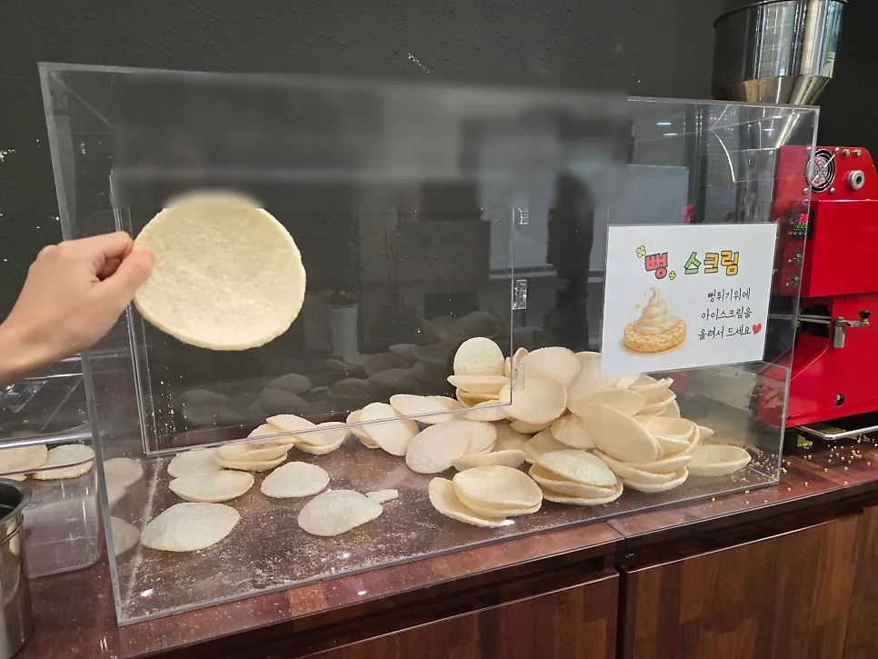 Self-serve coffee machine and cups at the dessert corner