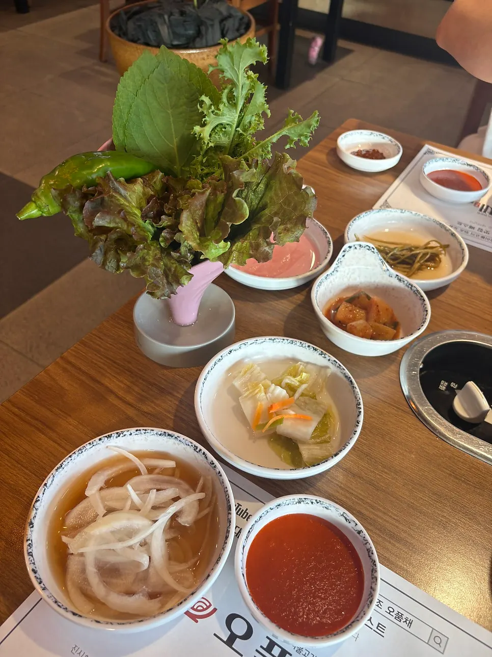 Vertical photo of a duck meat wrap being held