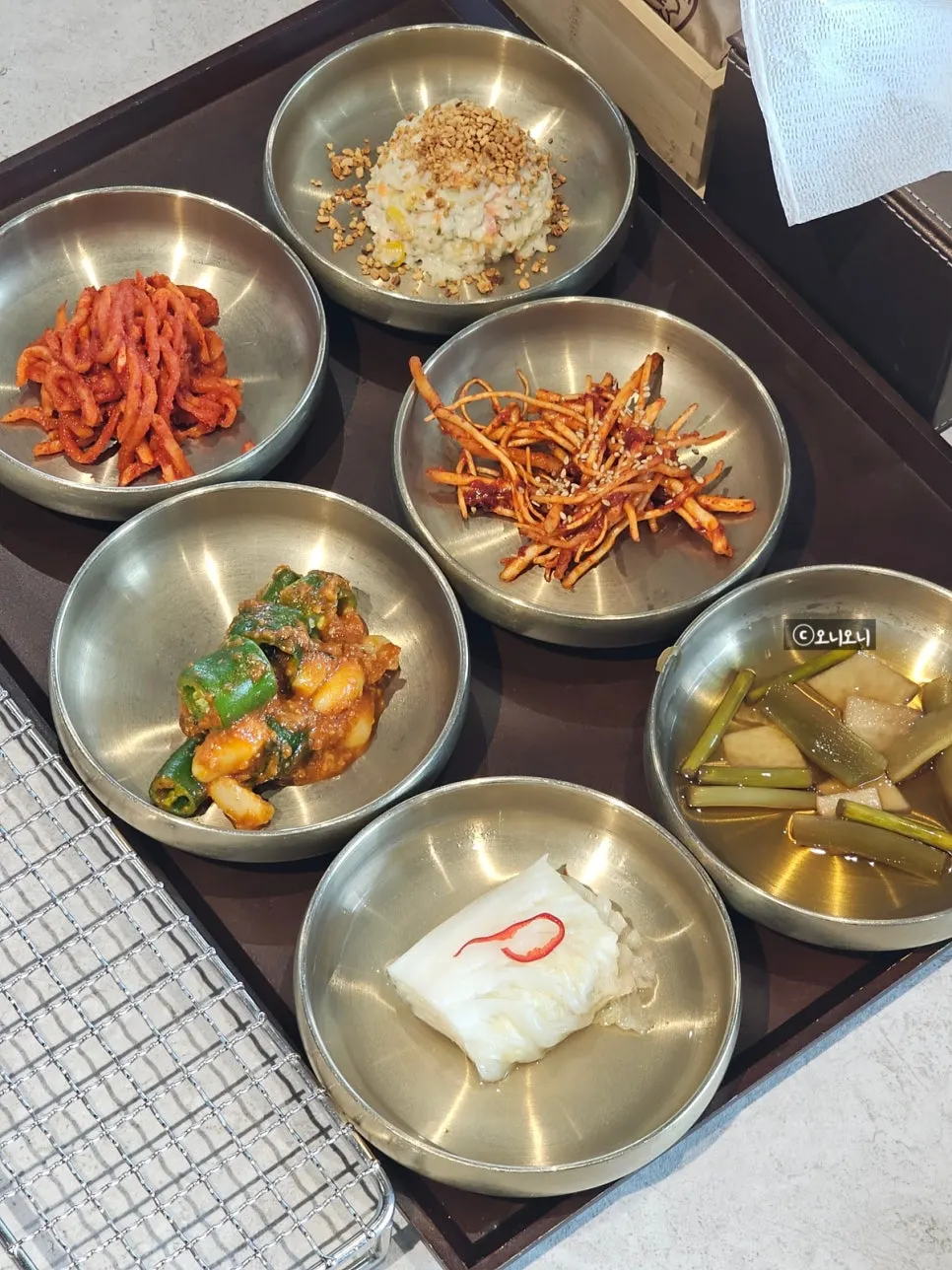 Basic side dishes including yukjeon and yukhoe at Manpo Garden