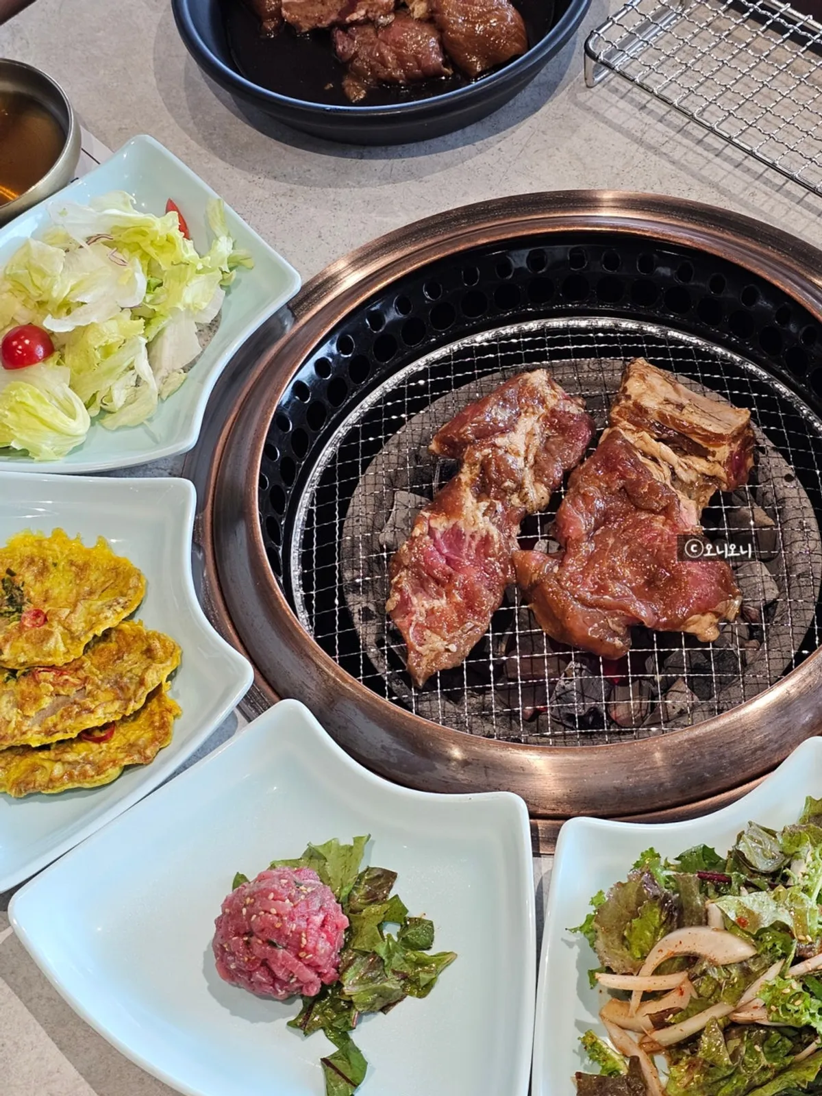 Marinated pork galbi grilling on the charcoal at Manpo Garden