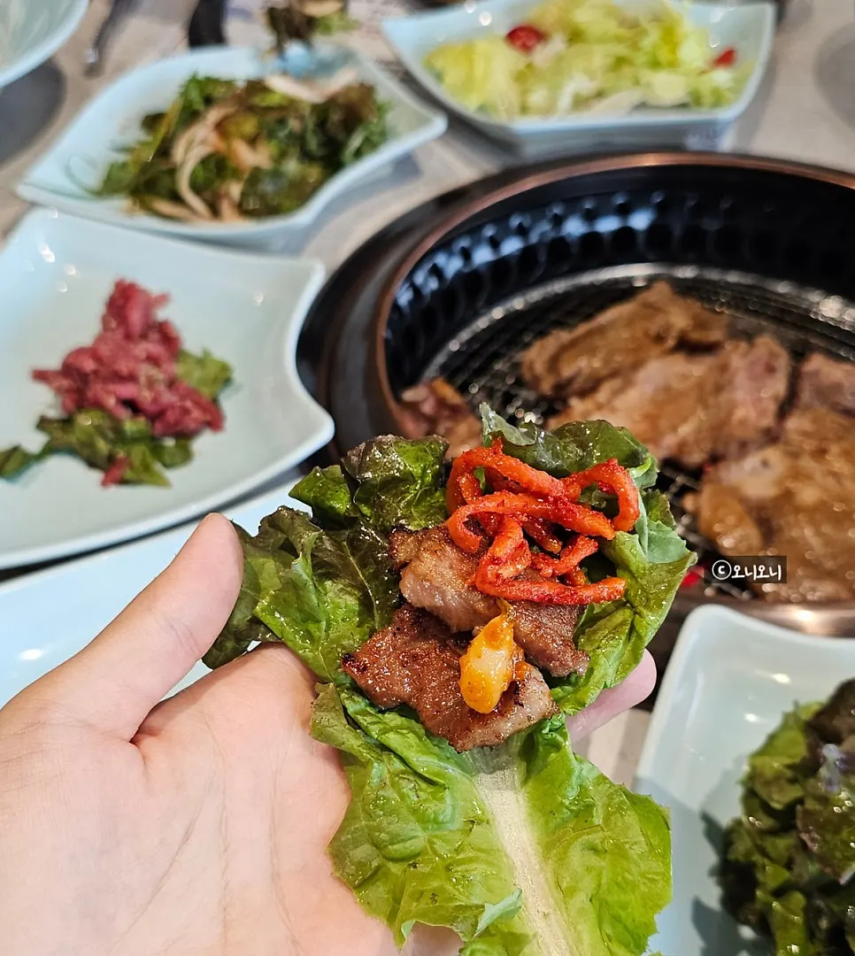 Piece of Manpo Garden pork galbi wrapped in a lettuce ssam