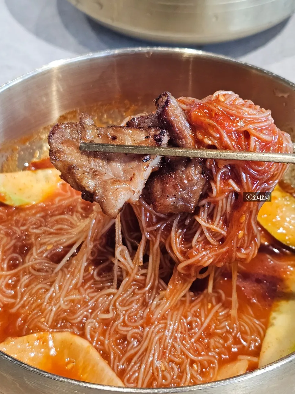 Pork galbi placed on top of bibim naengmyeon