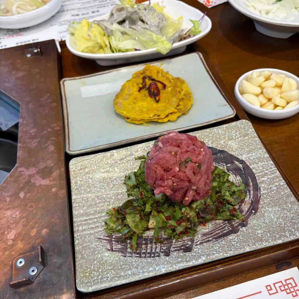 Full table with salad and onion sauce added
