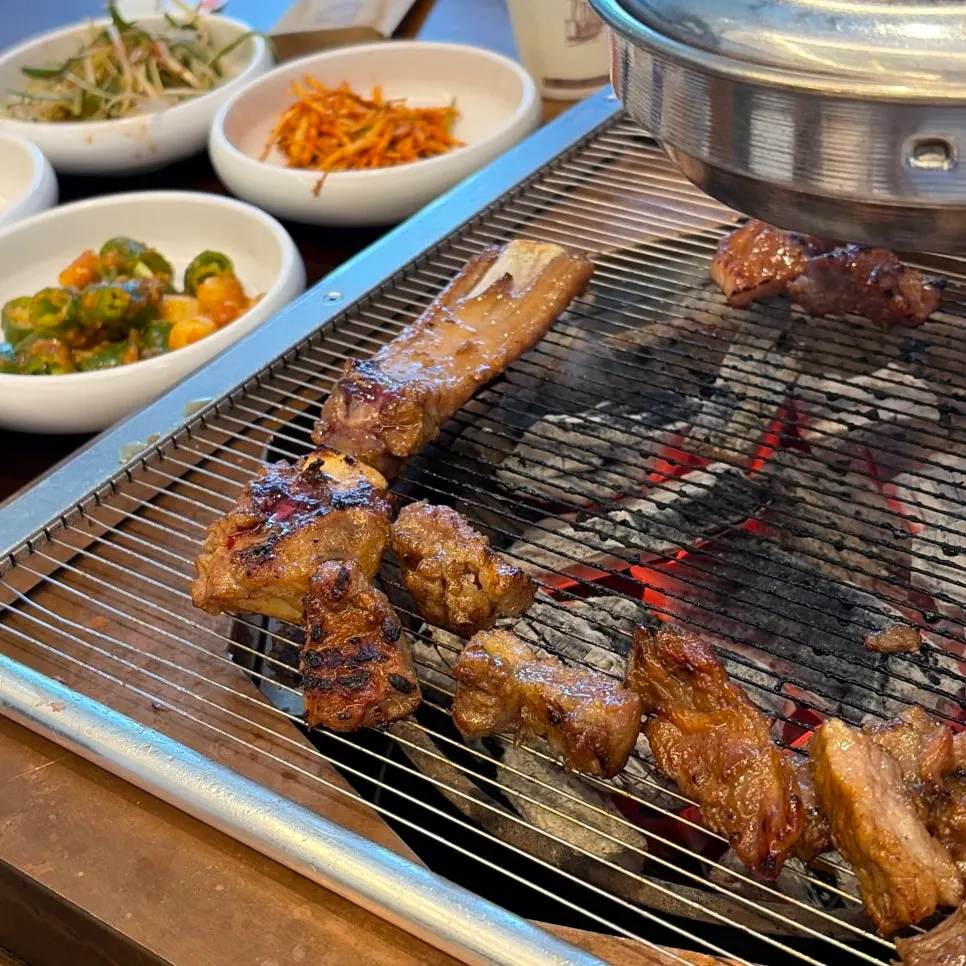 Ribs grilling over charcoal