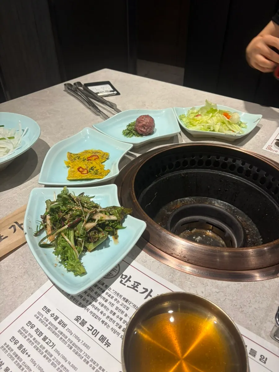 Basic side dishes including dressed lettuce, yukjeon, and yukhoe
